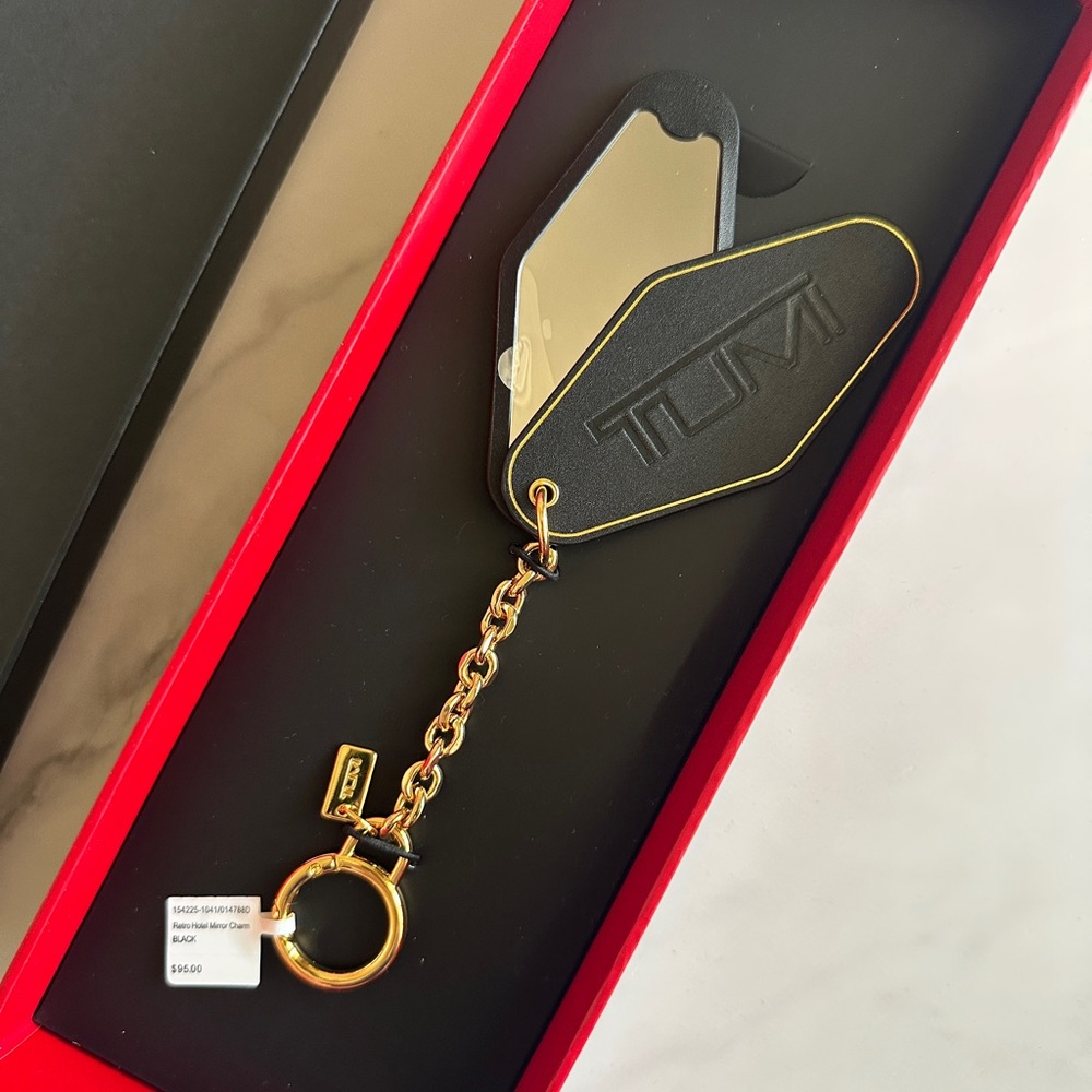 TUMI Black and Gold Retro Hotel Mirror Charm